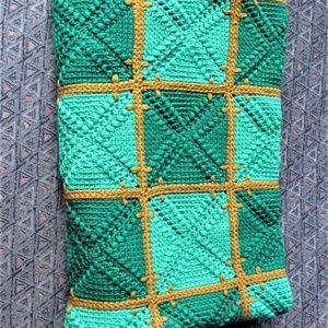 Hand knitted lap blanket, quilt; greens and orange